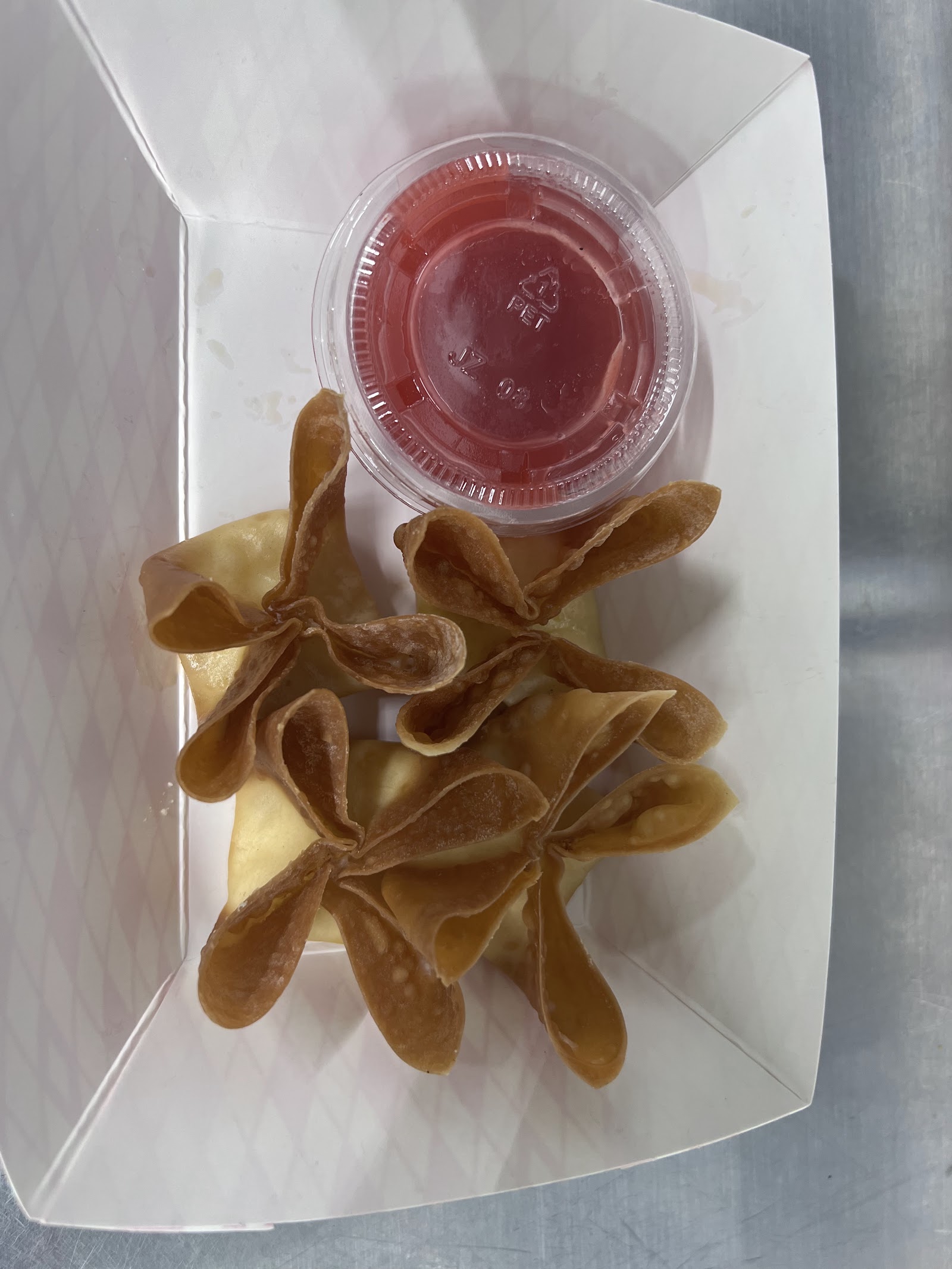 Crispy fried wontons with a side of dipping sauce